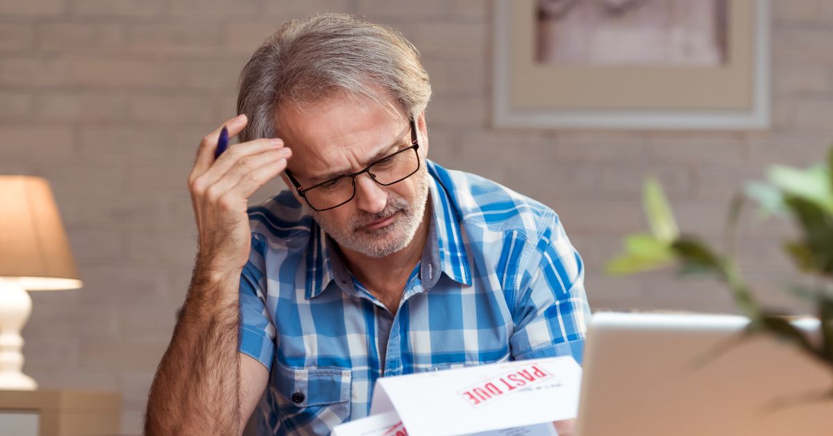 man stressing out about financial documents